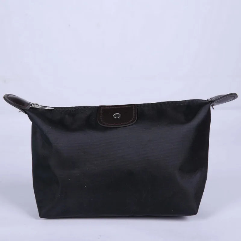 Waterproof Nylon Cosmetic Bag For Women, Cute Dumpling Shape, Zipper Makeup Travel Pouch shown in a compact solid-color design