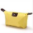 Waterproof Nylon Cosmetic Bag For Women, Cute Dumpling Shape, Zipper Makeup Travel Pouch shown in a compact solid-color design