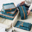 7-Piece Travel Packing Cubes Set, Waterproof PVC Luggage Organizer Bags For Clothes And Shoes shown together for organized suitcase packing