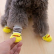 4-Piece Cute Pet Dog Socks, Printed Non-Slip Cat Shoes, Warm Polyester Paw Protectors showing soft knitted polyester fabric