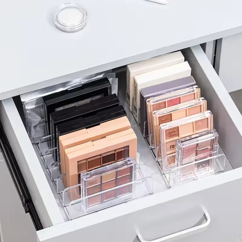 7-Compartment Makeup Organizer, Clear Eyeshadow Palette Storage Rack For Desktop Or Drawer arranged vertically on a vanity