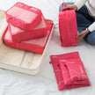 7-Piece Travel Packing Cubes Set, Waterproof PVC Luggage Organizer Bags For Clothes And Shoes packed inside a suitcase for space-saving organization
